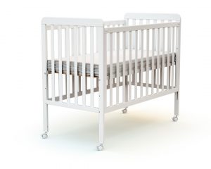 Dropside baby cot with flat slats.